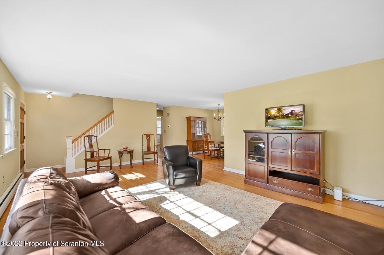 104 Fern Lane Moscow, PA 18444 - Photo 7 of 44 a living room with furniture a rug and white walls