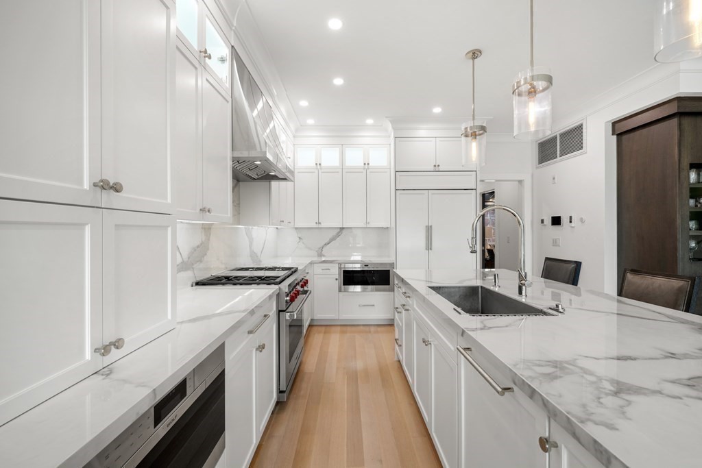 94 Beacon Street, Unit 4 Boston, MA 02108 - Photo 13 of 35 a large kitchen with stainless steel appliances granite countertop a lot of counter space and wooden floors