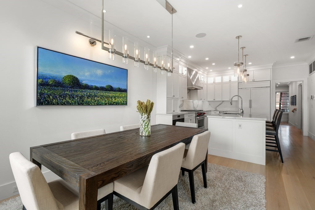 94 Beacon Street, Unit 4 Boston, MA 02108 - Photo 14 of 35 a dining hall with stainless steel appliances kitchen island a table chairs and a kitchen view