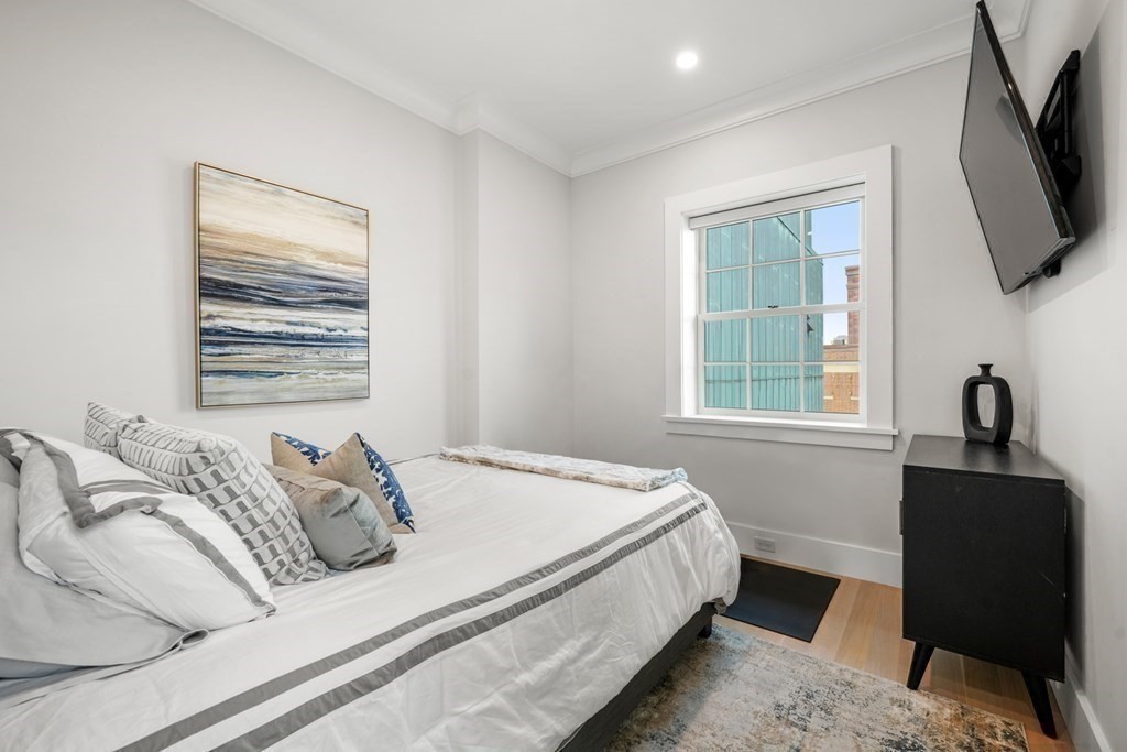94 Beacon Street, Unit 4 Boston, MA 02108 - Photo 22 of 35 a bedroom with a bed a flat screen tv and window