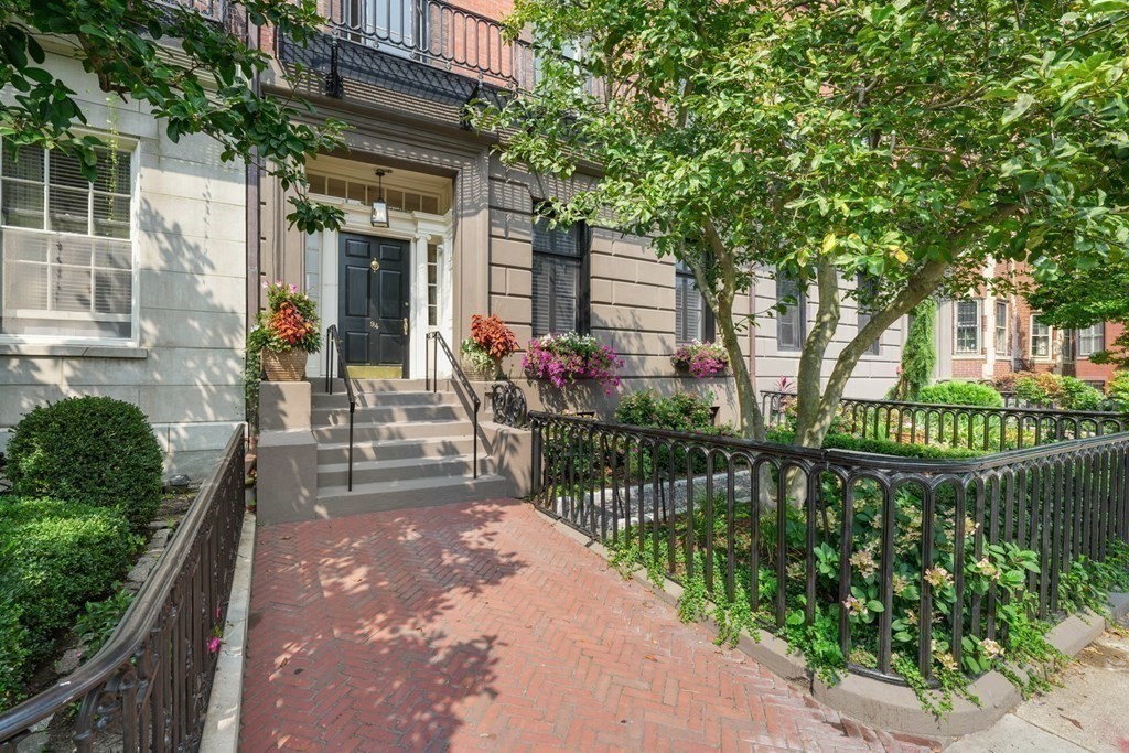 94 Beacon Street, Unit 4 Boston, MA 02108 - Photo 35 of 35 a view of a house with a small yard and wooden fence