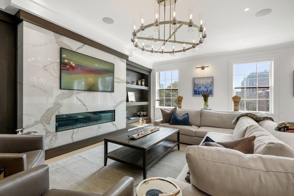 94 Beacon Street, Unit 4 Boston, MA 02108 - Photo 4 of 35 a living room with furniture a flat screen tv and a fireplace