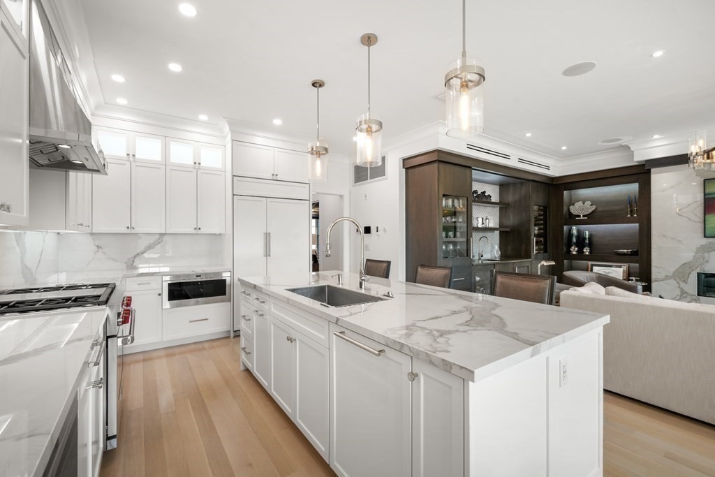 94 Beacon Street, Unit 4 Boston, MA 02108 - Photo 9 of 35 a large kitchen with kitchen island a large island a sink stainless steel appliances and cabinets