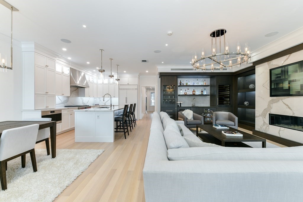 94 Beacon Street, Unit 4 Boston, MA 02108 - Photo 10 of 35 a living room with furniture a flat screen tv and kitchen view