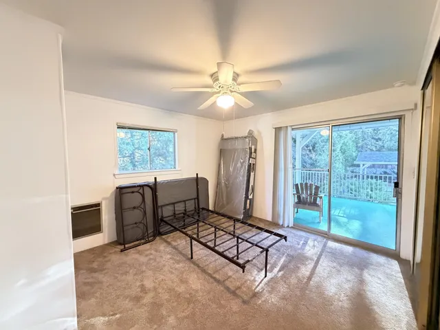 a living room with furniture a ceiling fan and a window
