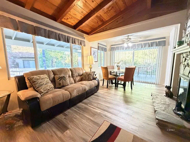 a living room with furniture a fireplace and a large window