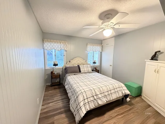 a bedroom with bed and window
