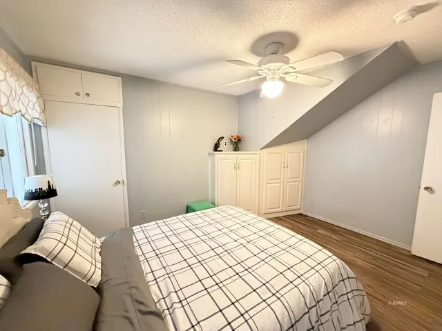 a bedroom with a large bed and a chandelier