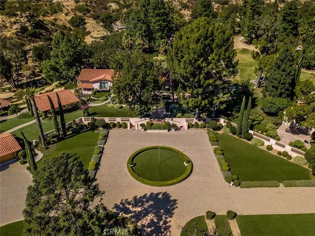 an aerial view of a house with yard swimming pool and outdoor seating
