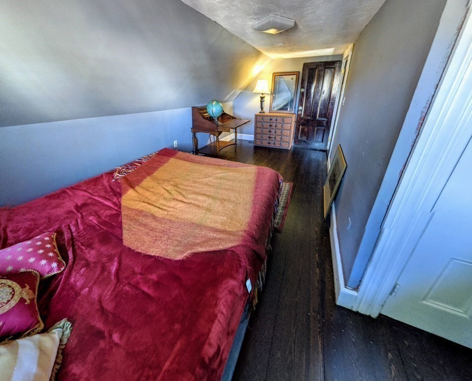 74 Sydney Street, Unit 2 Boston, MA 02125 - Photo 16 of 28 a bed sitting in a bedroom next to a window