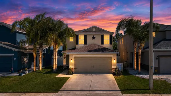 a front view of a house with a yard and garage