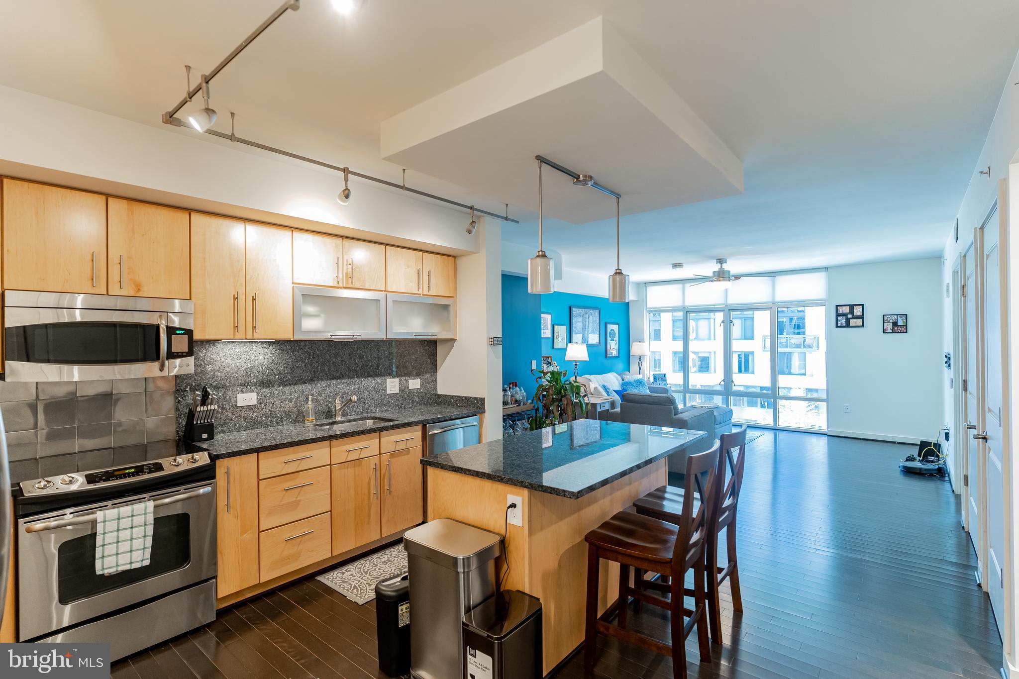 1025 First Street Southeast, Unit 514 Washington, DC 20003 - Photo 5 of 15 a kitchen with a stove a sink and chairs