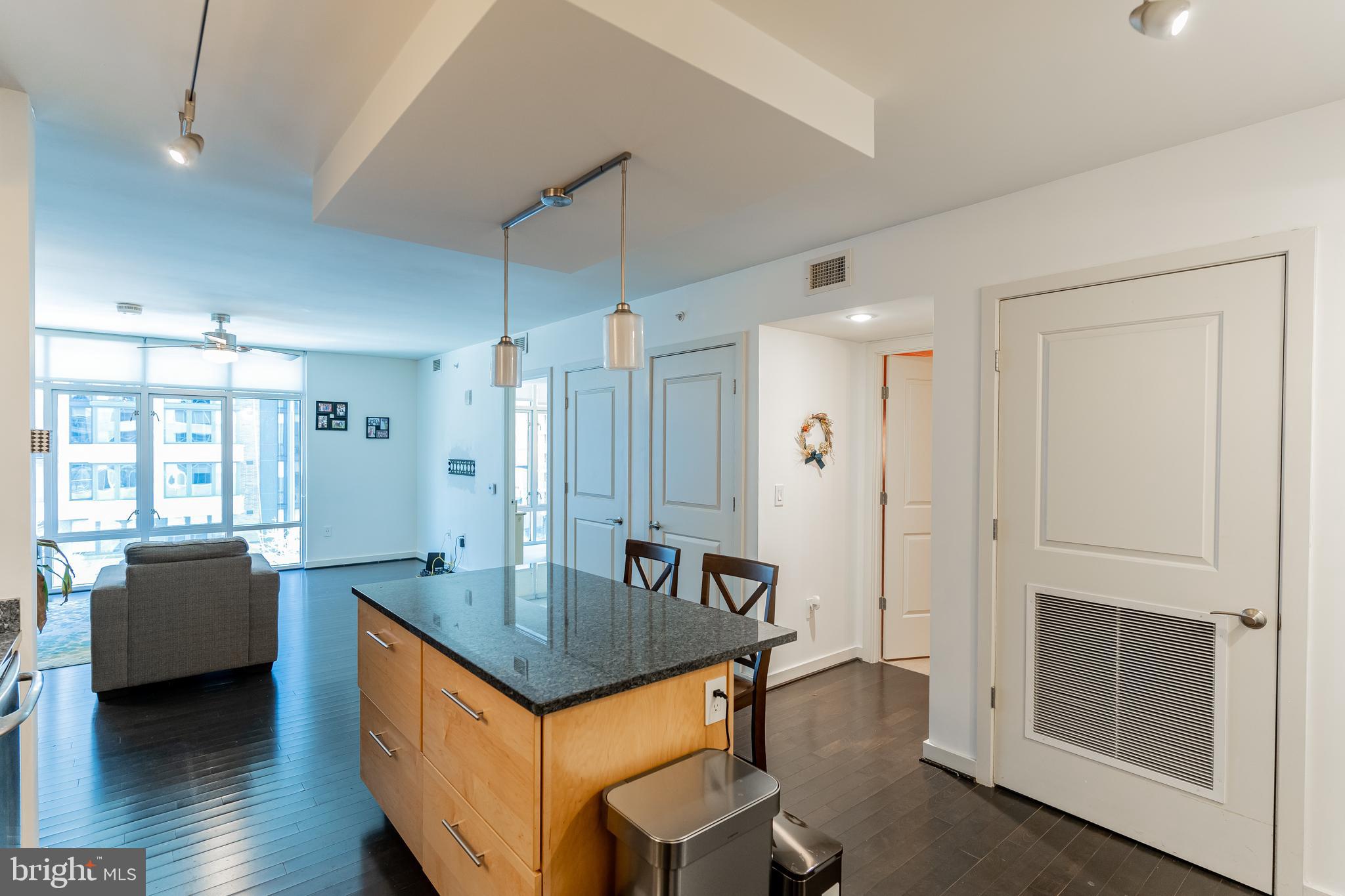1025 First Street Southeast, Unit 514 Washington, DC 20003 - Photo 6 of 15 a kitchen with granite countertop a sink stove and refrigerator