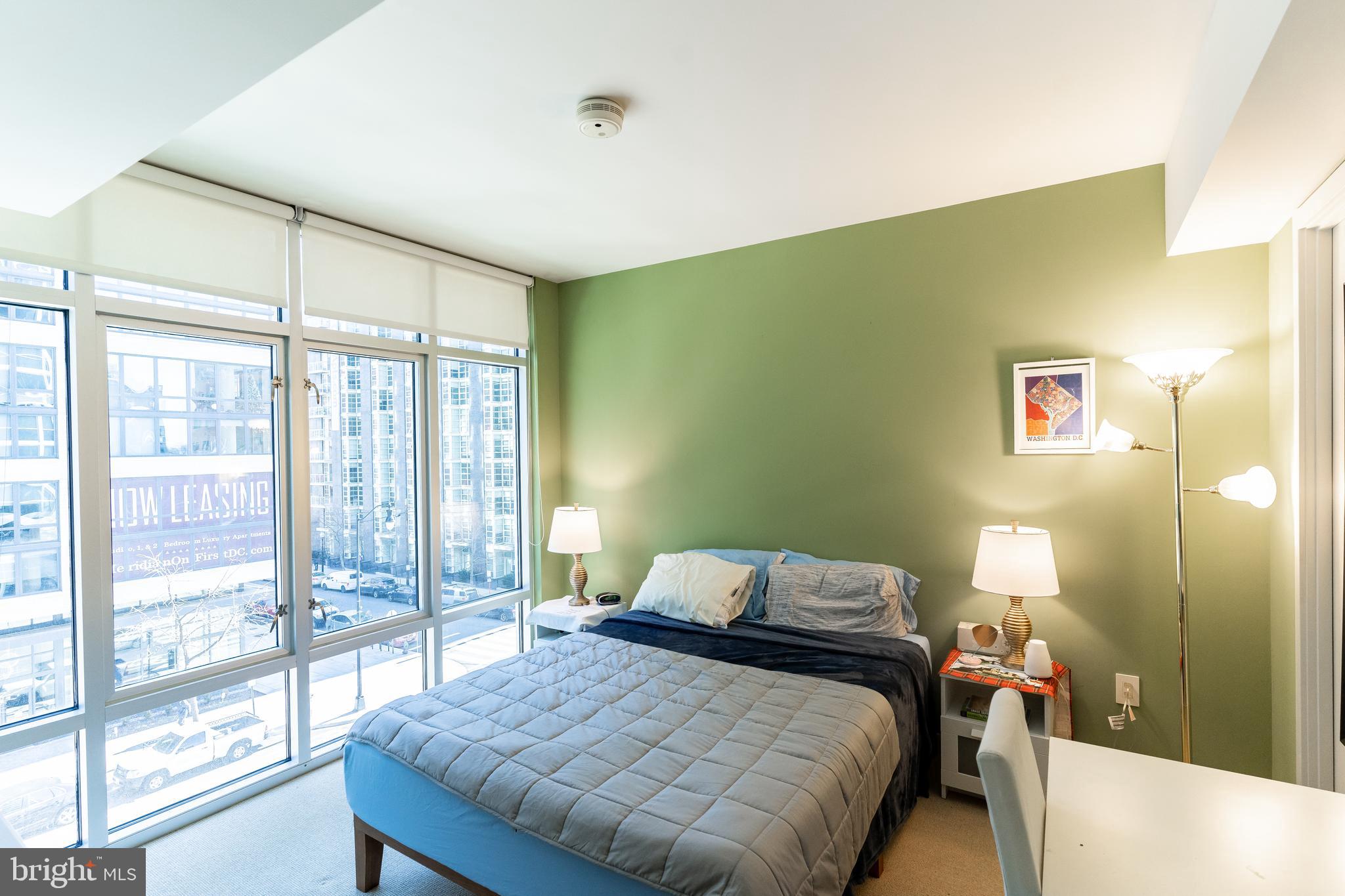 1025 First Street Southeast, Unit 514 Washington, DC 20003 - Photo 7 of 15 a bedroom with a bed and a large window