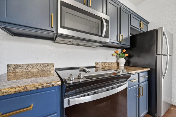 a kitchen with stainless steel appliances granite countertop a sink and stove top oven
