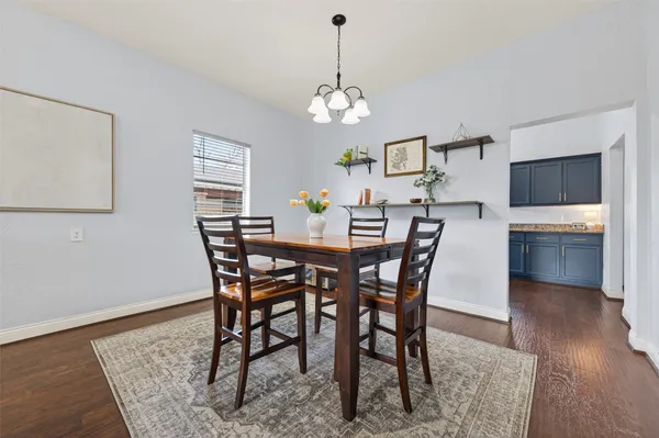 a kitchen with stainless steel appliances granite countertop a stove top oven a sink dishwasher and a refrigerator with wooden cabinets