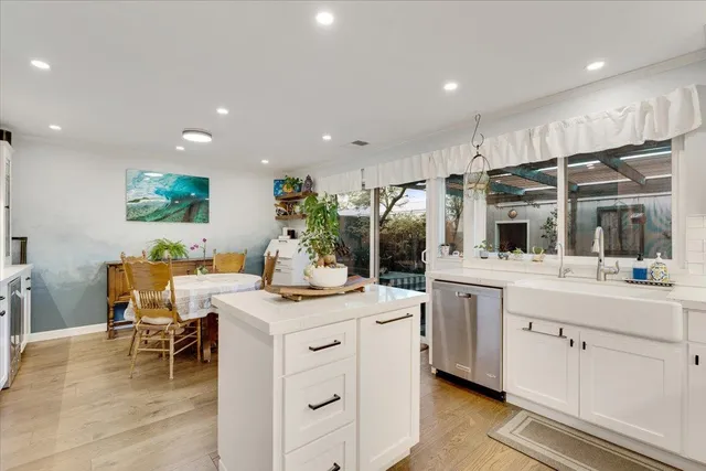 a kitchen with a stove a sink a dining table and chairs