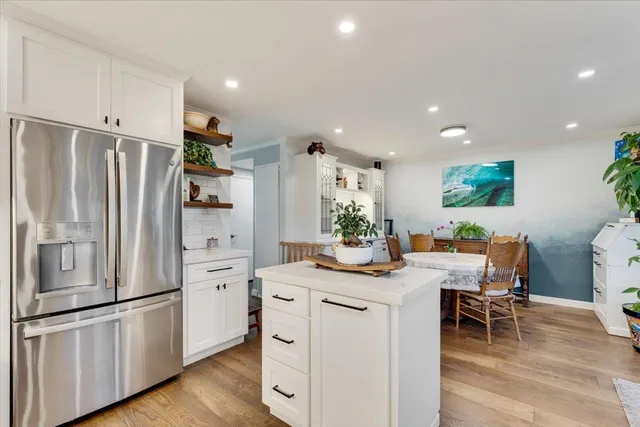 a kitchen that has a lot of cabinets in it and appliances