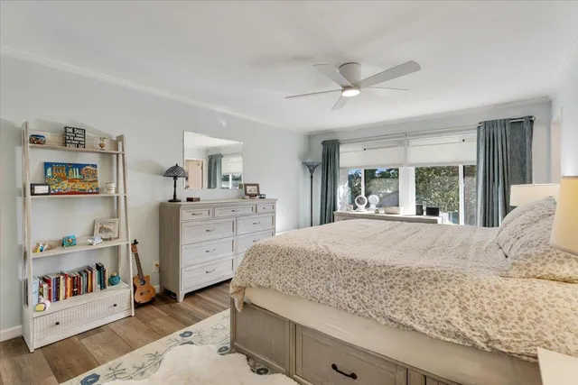 a bedroom with a large bed a dresser and book shelf