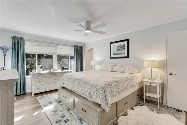 a spacious bedroom with a bed and a large window