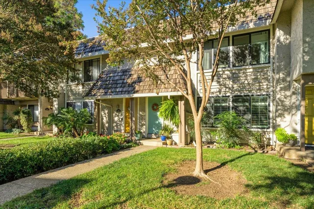 a view of a white house with a yard