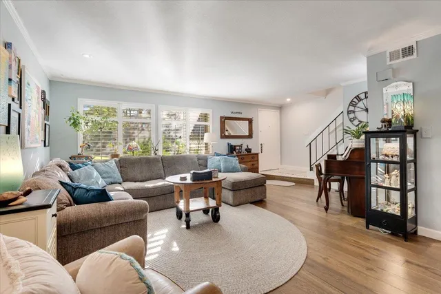 a living room with furniture and wooden floor