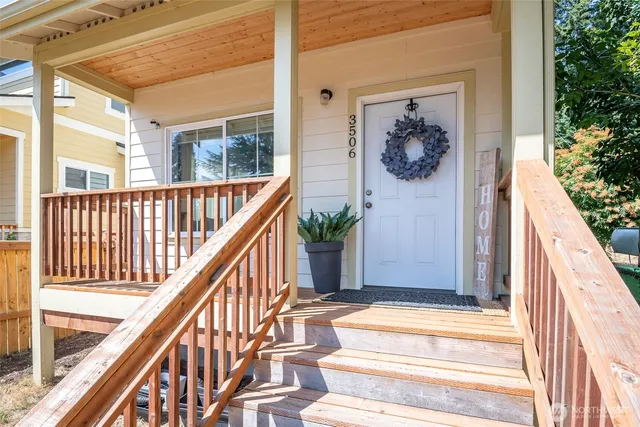a view of entryway with wooden floor and a front door