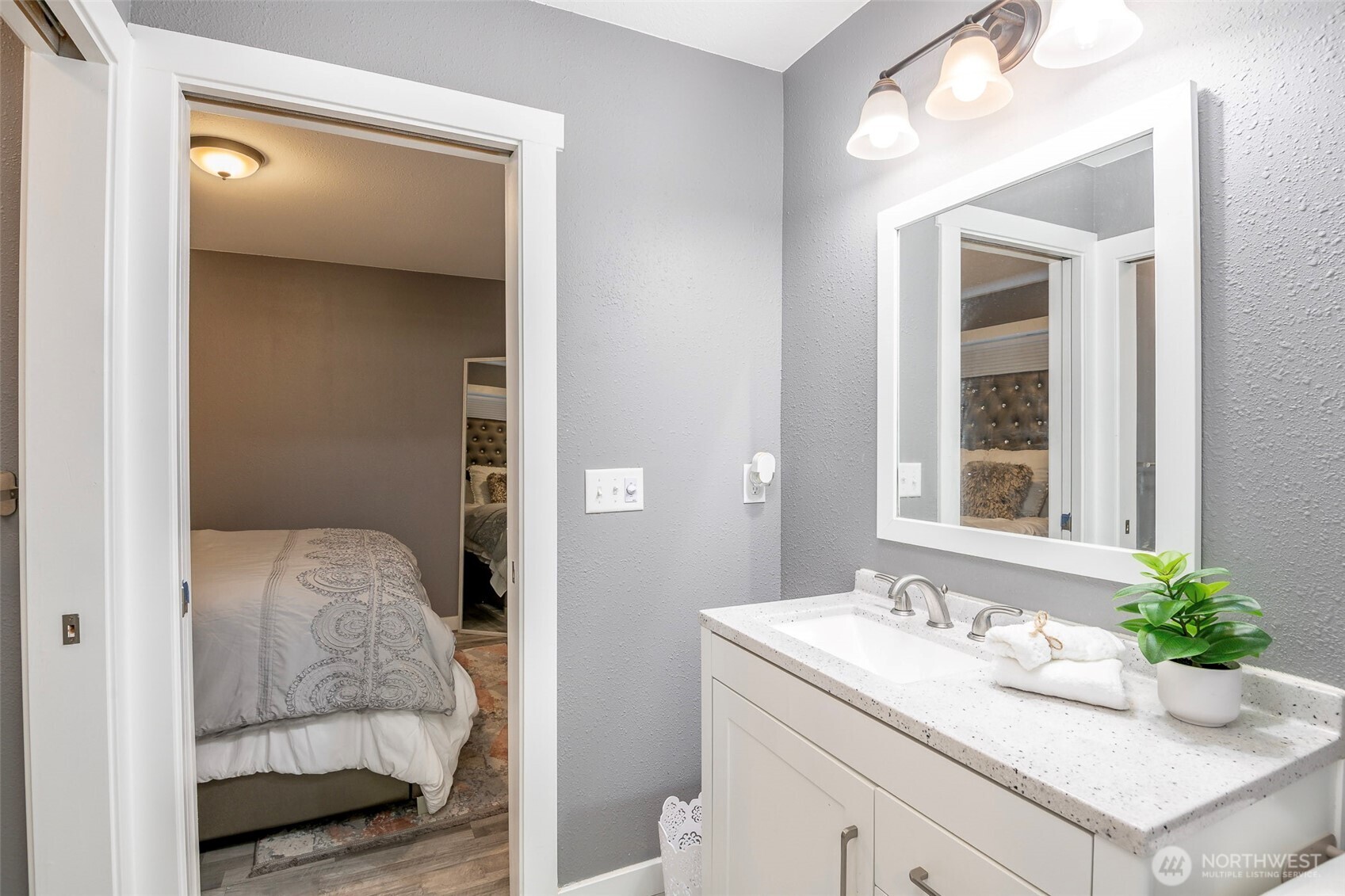 3506 South Tyler Street Tacoma, WA 98409 - Photo 12 of 32 a en suite bathroom with a granite countertop sink and a mirror