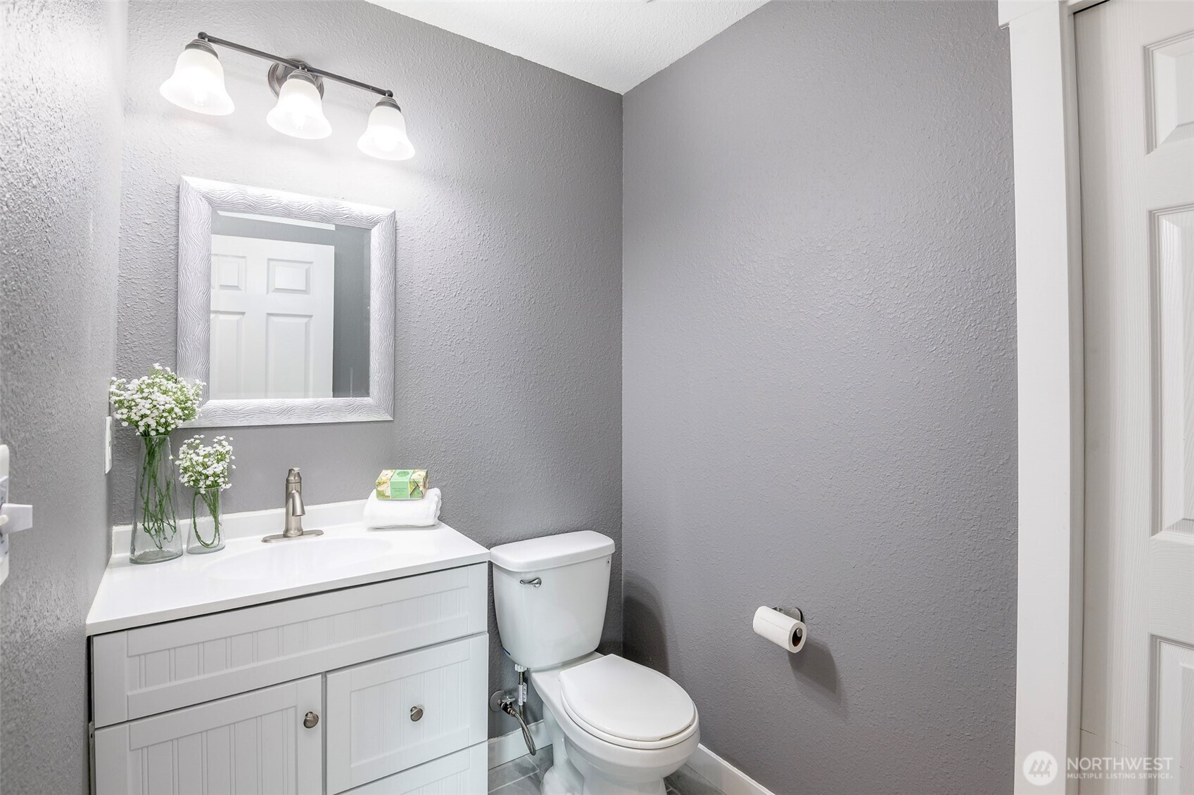 3506 South Tyler Street Tacoma, WA 98409 - Photo 13 of 32 a bathroom with a toilet a sink and mirror