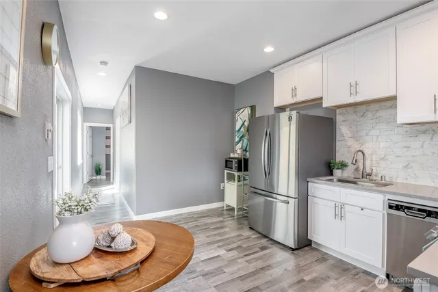 a kitchen with stainless steel appliances a refrigerator and a stove