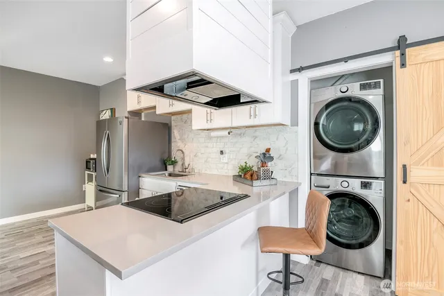 a kitchen with a stove top oven and a sink