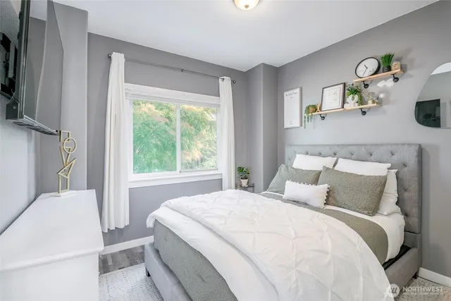 a bedroom with a bed and a window