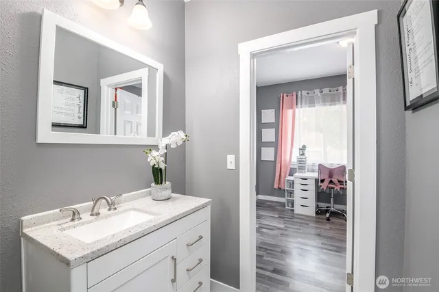 a bathroom with a sink vanity and mirror