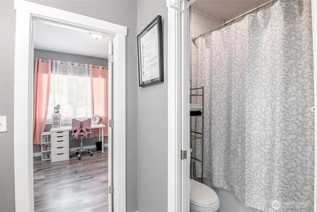 a bathroom with a toilet a sink and a mirror