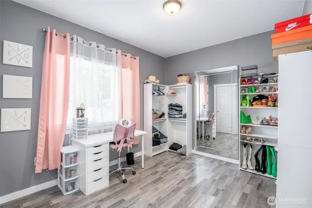 a room with furniture a rug toys and windows