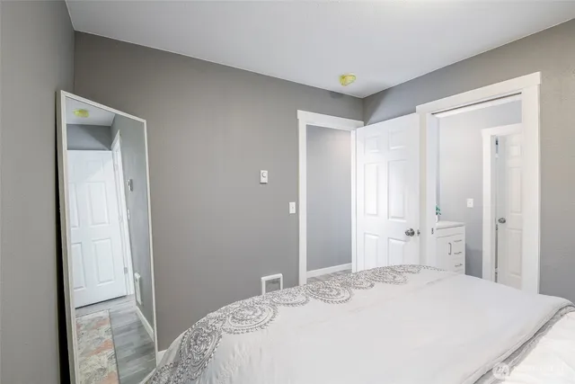 a bedroom with a bed and a bathroom