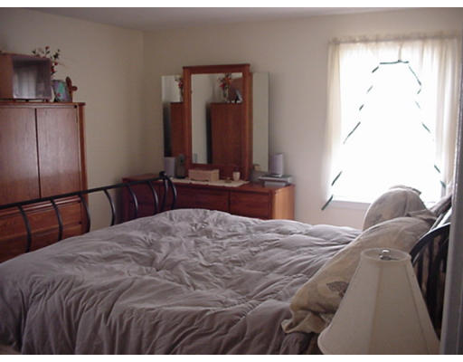 122 Bairdcrest Road Springfield, MA 01118 - Photo 7 of 10 a bedroom with a bed and wooden floor