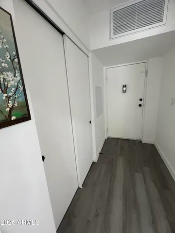 a view of a hallway with wooden floor