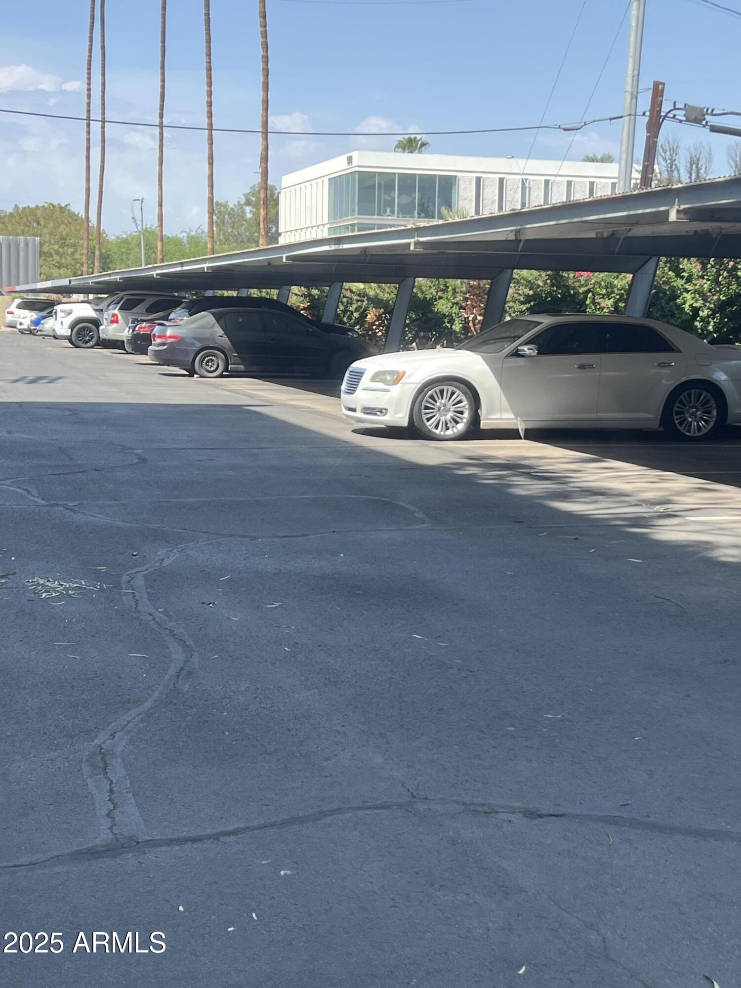 353 East Thomas Road, Unit C104 Phoenix, AZ 85012 - Photo 16 of 17 a front view of a building with parking area