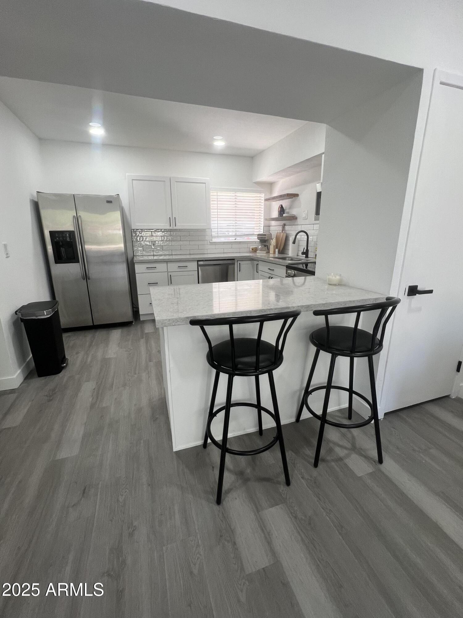353 East Thomas Road, Unit C104 Phoenix, AZ 85012 - Photo 2 of 17 a view of a dining room with furniture and wooden floor