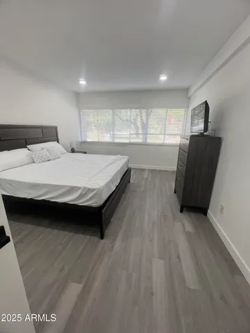 a spacious bedroom with a bed and a window