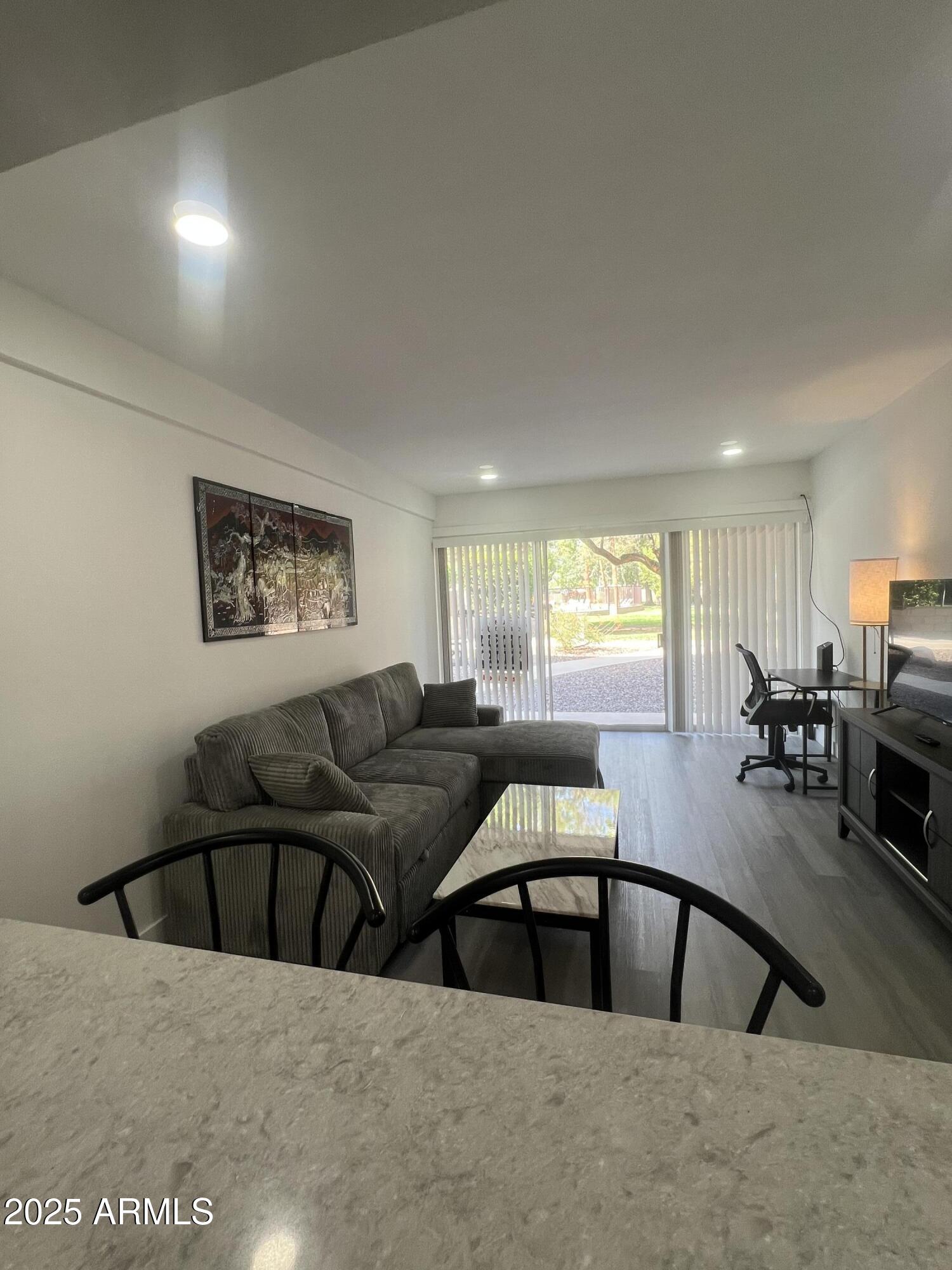 353 East Thomas Road, Unit C104 Phoenix, AZ 85012 - Photo 7 of 17 a living room with furniture and a large window