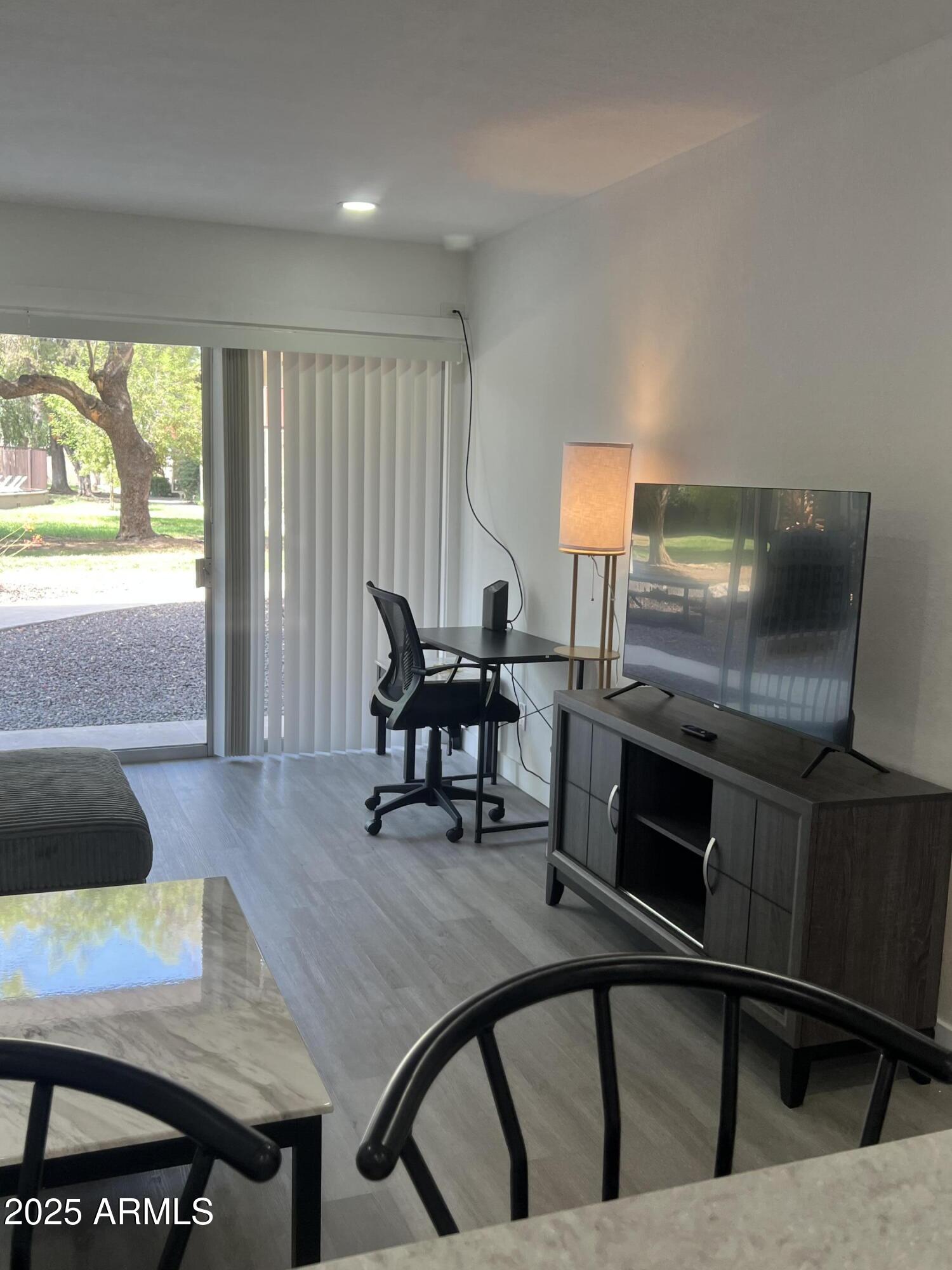 353 East Thomas Road, Unit C104 Phoenix, AZ 85012 - Photo 8 of 17 a dining room with furniture and wooden floor
