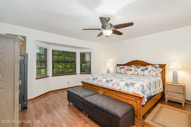 a bed sitting in a bedroom next to a window