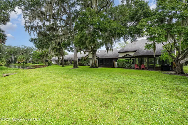 a view of a house with a backyard porch and sitting area