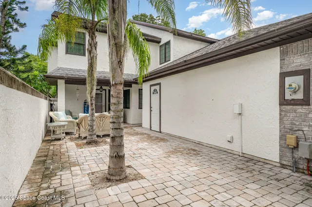 a backyard of a house with outdoor seating