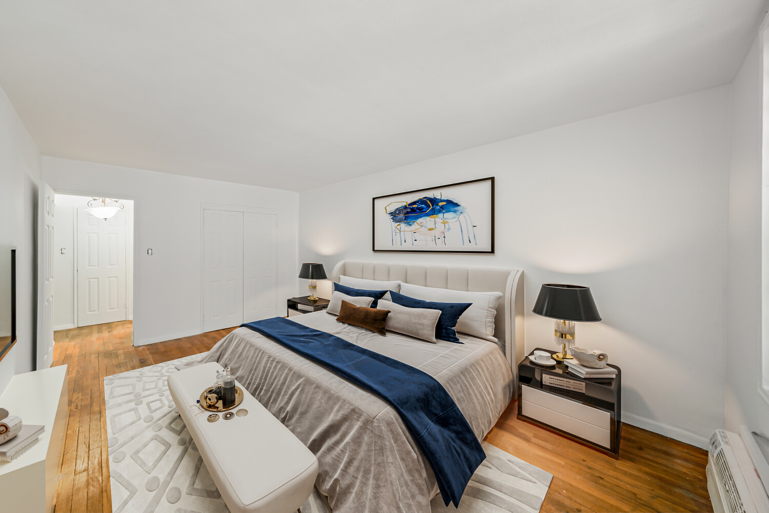 a bedroom with a bed and wooden floor