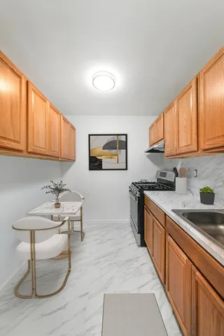 a kitchen with stainless steel appliances granite countertop a sink and cabinets