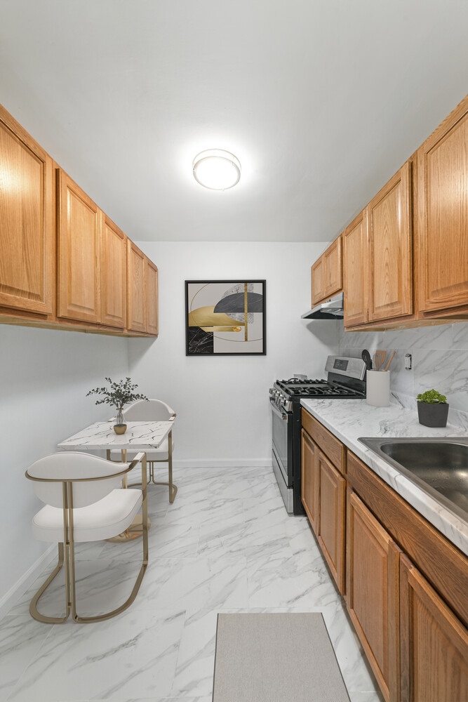310 Lenox Road, Unit 4U Brooklyn, NY 11226 - Photo 3 of 4 a kitchen with stainless steel appliances granite countertop a sink and cabinets