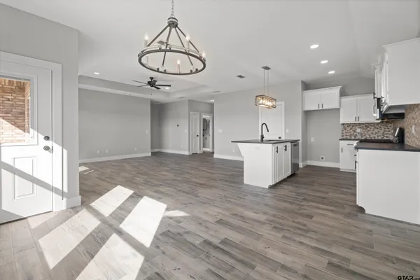 a kitchen with stainless steel appliances granite countertop a stove and white cabinets